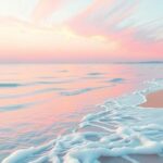 Suasana damai di tepi pantai dengan ombak lembut, menenangkan perasaan dan pikiran dengan warna pastel yang lembut.
